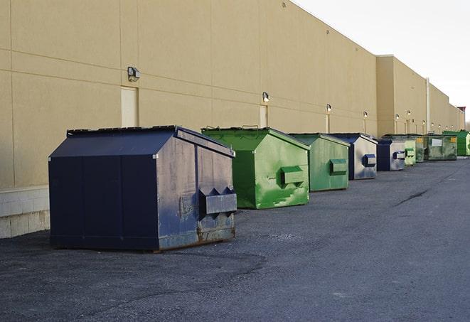 a row of industrial dumpsters at a construction site in Alma, IL